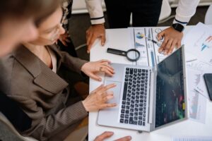Sales professionals researching on a laptop, representing Google AI Mode changing B2B sales