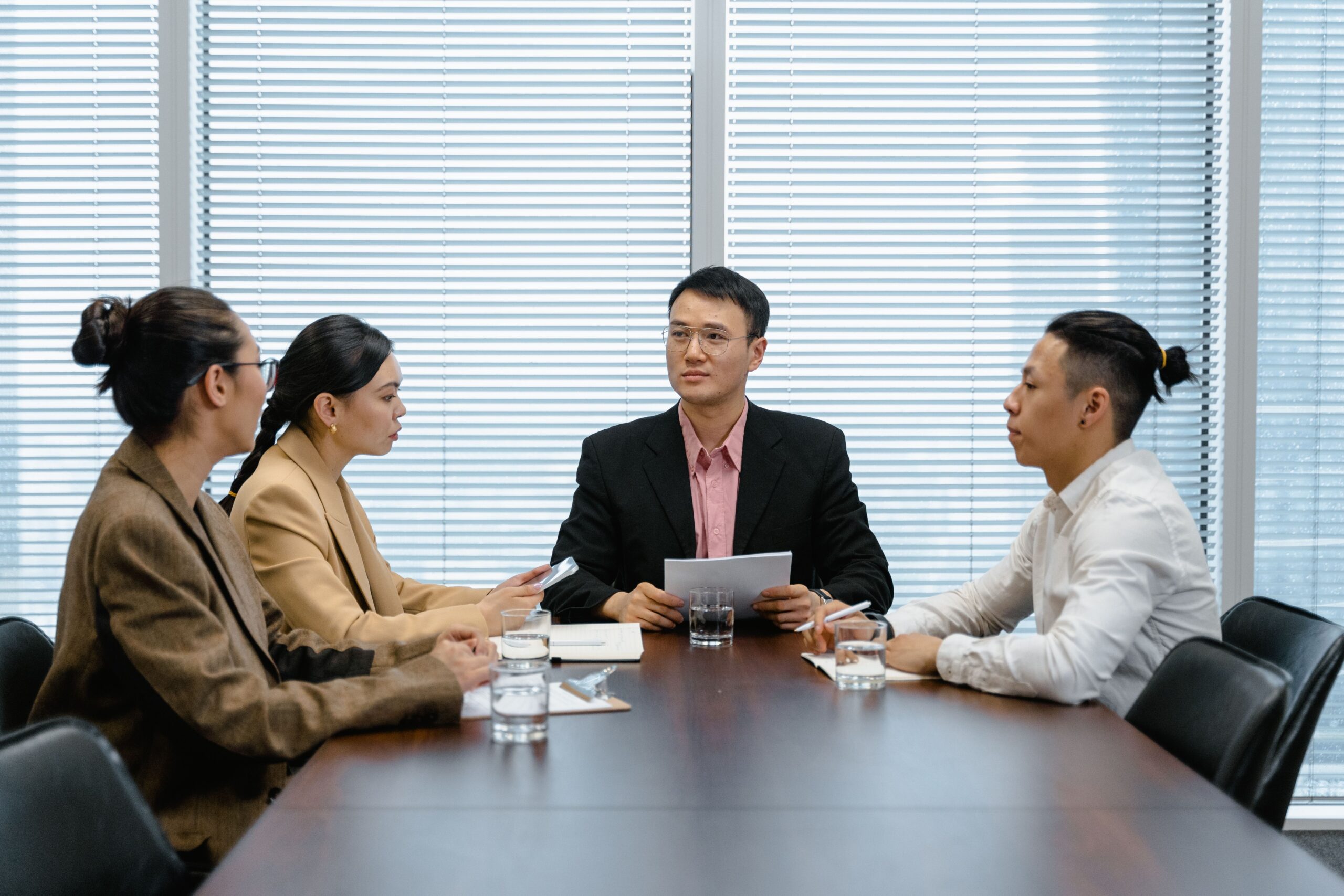 Business leaders in a strategy meeting discussing AI marketing trends