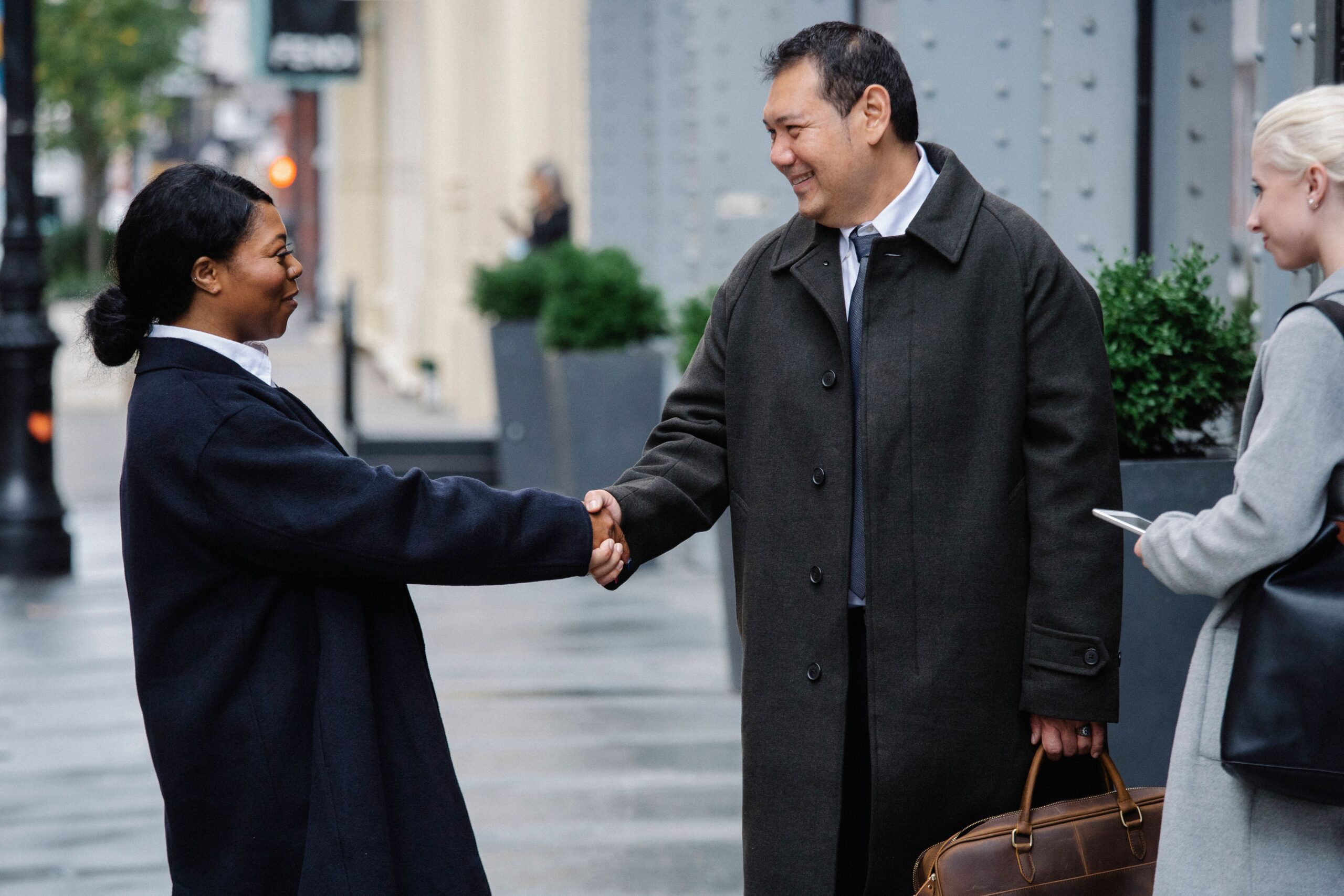 Professionals greeting in a city street, representing LinkedIn business growth