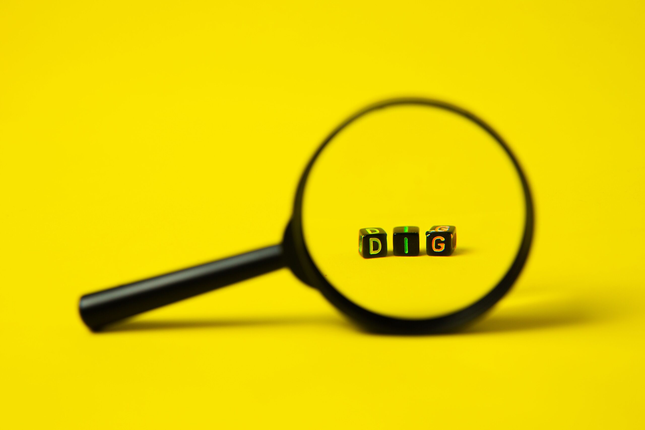 Magnifying glass over colorful data representing SEO and AI search visibility